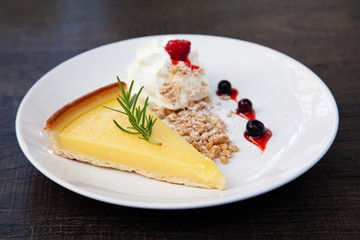 Fresh tasty lemon tart with crumble and whipped cream