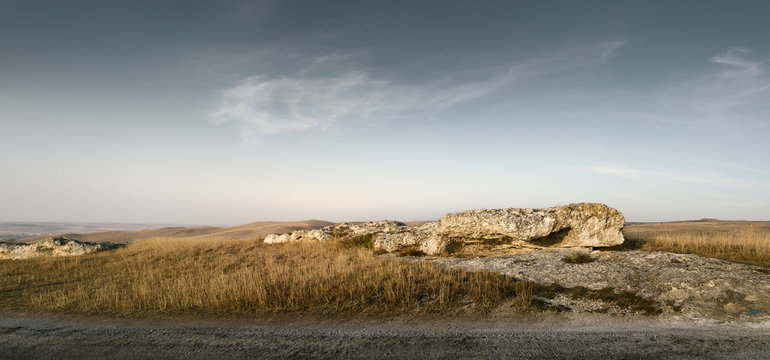 Panorama of a autumn field. Open space under dramatic sky