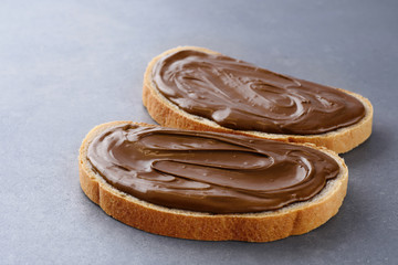 Toasts with chocolate butter on gray texture.