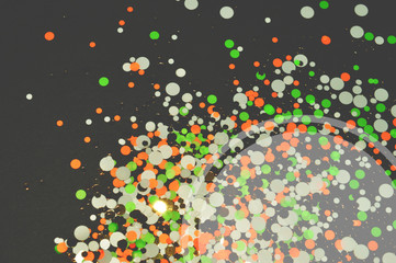 Colorful glitter in vintage colors on black background with place for your text, shiny confetti, kamifubiki nail art