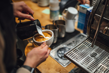 Barista makings coffee in coffee shop, cappuccino making