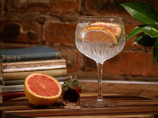 Glass of gin with grapefruit and thyme 