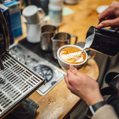 Barista makings coffee in coffee shop, cappuccino making