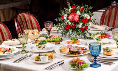 Beautiful restaurant interior table decoration for wedding or event. Flower Wedding Table Decoration, Autumn colors. European food in a restaurant setting. Table set for party.