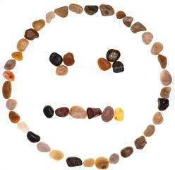 Emoji (emoticon) of neutral face (poker face) handmade with stones (boulders). Isolated on white background Collection made with stones.