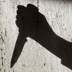 Shadow of the hand holding a knife