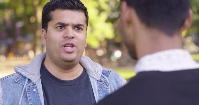 Medium Shot - Indian man argues with another man while at the park - Slow Motion - shot on RED