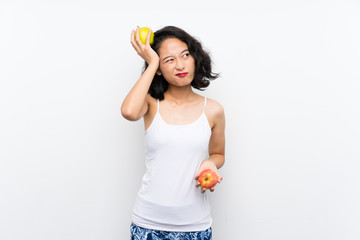 Asian young woman with an apple over isolated white background