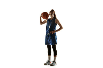 Young caucasian female basketball player of team posing confident with ball isolated on white...