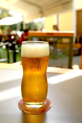 beer mug on a wooden table stands in a pub