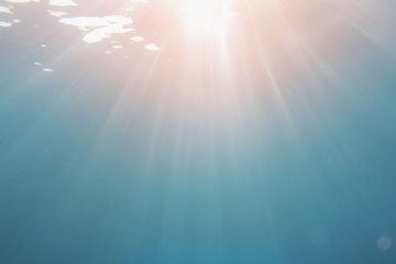 Life-giving sunlight underwater. Sun beams shinning underwater . Abstract background