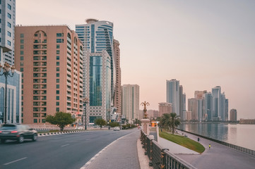 Fototapeta na wymiar Evening In Sharjah. Cityscape with skyscrapers. UAE. 