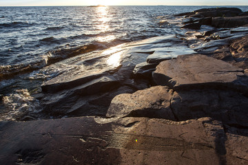 ancient rock carvings petroglyphs on the shore of Onega Lake carved on a granite plate . Age of...