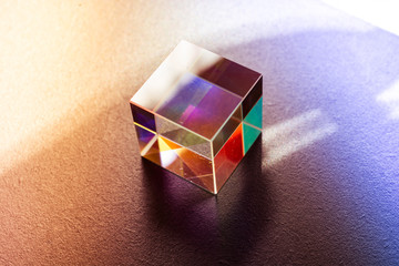Colorful bright glass prism cube  Refracting light in vivid rainbow colors.