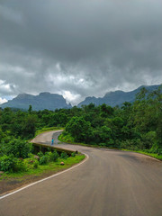 NASIK, MAHARASHTRA, August 2018, Man standing at the edge of road to Bhandardara