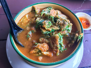 close up of Sour Curry with Vegetable Omelet, Thai style