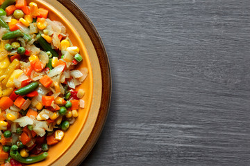 vegetables and potatoes close up on a plate on the table. horizontal