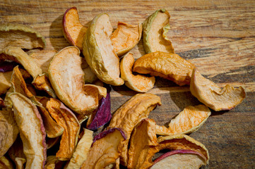 Dried sliced apples, healthy, closeup shot on a wooden surface.