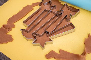Do it yourself: Gingerbread cookies tutorial. Step by step recipe. Step 15. Cut out as many cookies as possible from rolled dough.