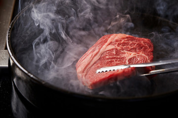 Beef steak on hot iron plate - Powered by Adobe