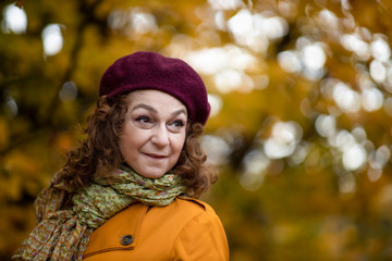 Seasonal portrait of a mature woman outdoor in vibrant forest