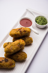 Veg Poha Roll made using flattened Rice, served with tomato ketchup and green chutney