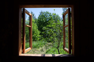 Open wooden window overlooking the summer garden