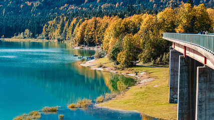 Beautiful alpine autumn or indian summer view with reflections at the famous Sylvenstein lake, Bavaria, Germany