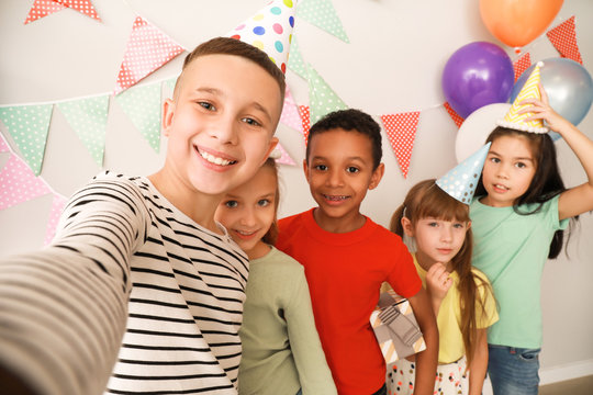 Happy children taking selfie at Birthday party