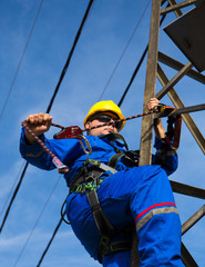 Technician prepares safety belt to work on lamppost