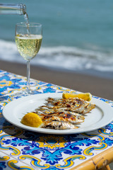 Espeto, Malaga style fish on stick barbecue prepared on olive tree firewoods and white wine