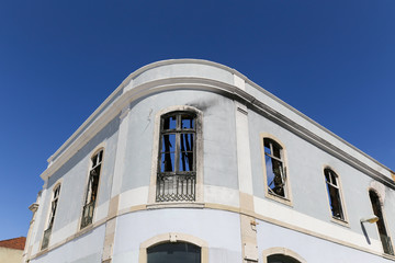 Fototapeta na wymiar Abandoned detail of burnt building in Lisbon, Portugal with blue sky