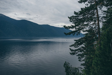 Lake Teletskoye in the mountains. In the evening you can see the hills and nature. Altai region