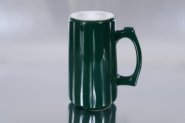 Green mug isolated on silver ground-