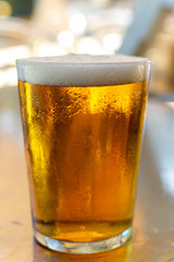 Cold amber color light spanish beer served in glass in outdoor cafe in sunny Andalusia, Spain