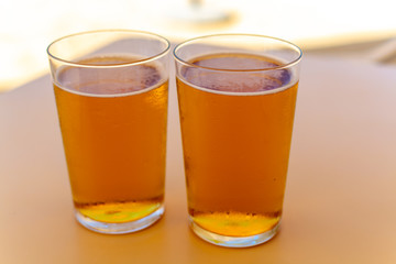 Fototapeta na wymiar Cold amber color light spanish beer served in glass in outdoor cafe in sunny Andalusia, Spain