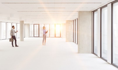 Fototapeta premium Businessman and woman planning in new empty workspace