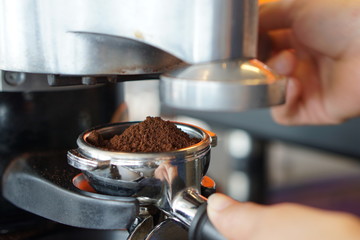 Side view of Coffee grinder making step in coffee shop.