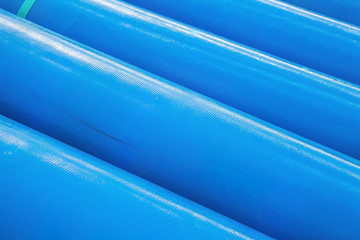 Stack of new blue pipes (tubes)