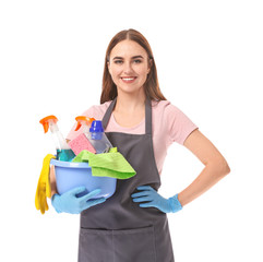 Female janitor with cleaning supplies on white background