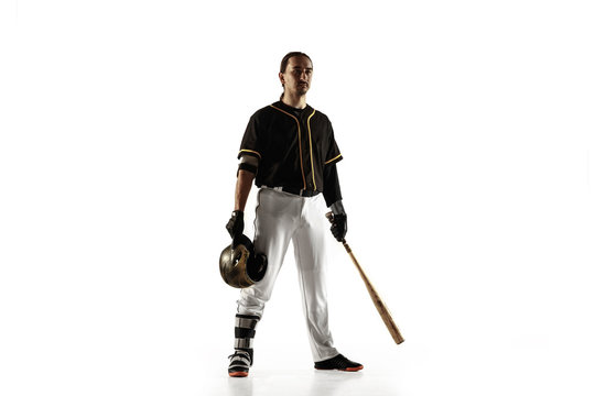 Baseball Player, Pitcher In A Black Uniform Practicing And Training Isolated On A White Background. Young Professional Sportsman In Action And Motion. Healthy Lifestyle, Sport, Movement Concept.