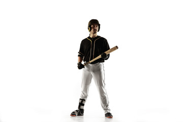 Baseball player, pitcher in a black uniform practicing and training isolated on a white background. Young professional sportsman in action and motion. Healthy lifestyle, sport, movement concept.