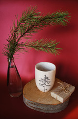 Obraz na płótnie Canvas Ceramic cup with pine illustration. Pottery design. Christmas decor.