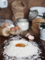 baking tray with pastry roll with raspberry jam with ingredients on a wooden rustic baking sheet