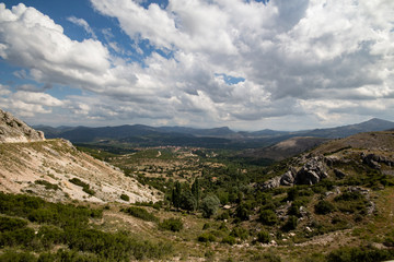 Fototapeta na wymiar Rocky mountain slopes, sky background in landscape, forest view