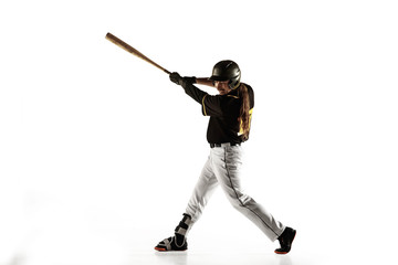 Baseball player, pitcher in a black uniform practicing and training isolated on a white background. Young professional sportsman in action and motion. Healthy lifestyle, sport, movement concept.