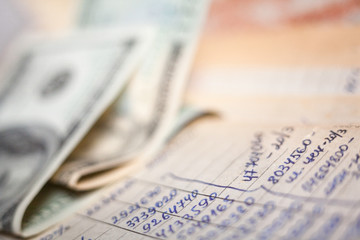 Calculations and 100-dollar bills.