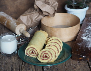 pastry roll on a green plate with ingredients on a brown background