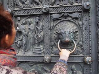A woman grasping a piece of art made into a door, Bremen, Germany