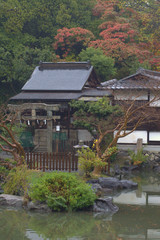 Fototapeta na wymiar Small Japanese shinto shrine in an autumnal park